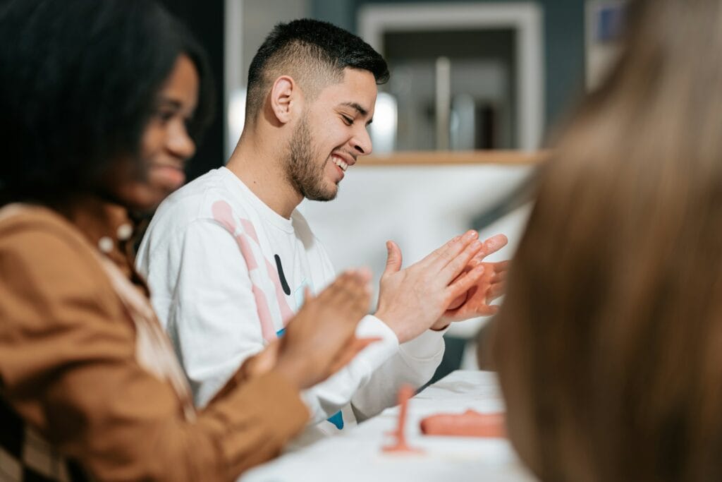 Group therapy session with diverse individuals engaging in mental health support.