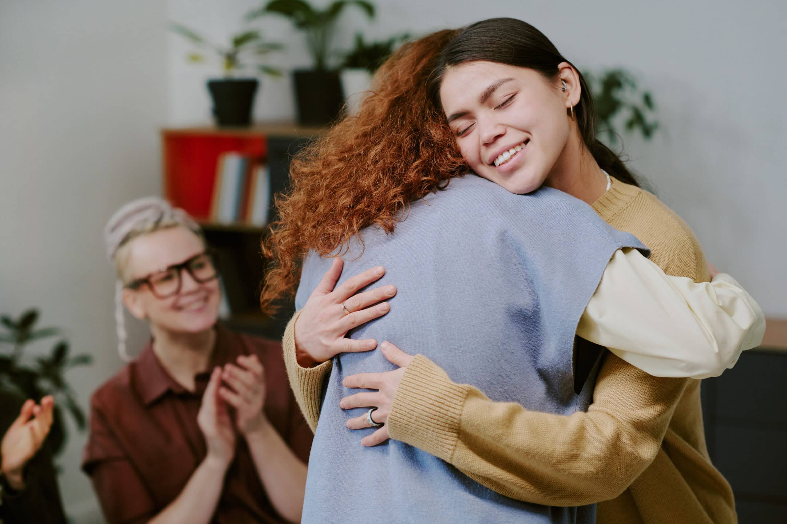 Women hugging for mental health and emotional well-being support.