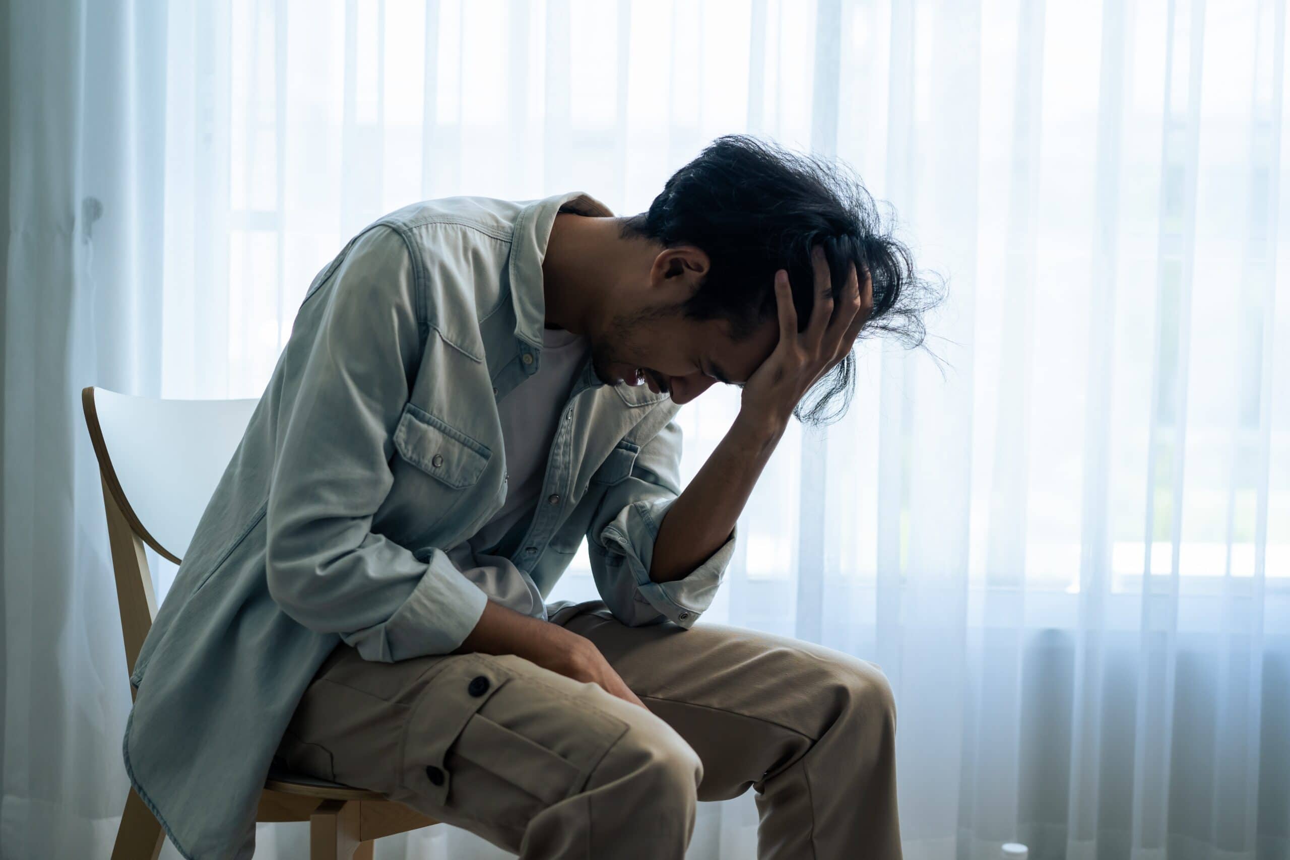Stressed man asking himself can severe anxiety cause psychosis.